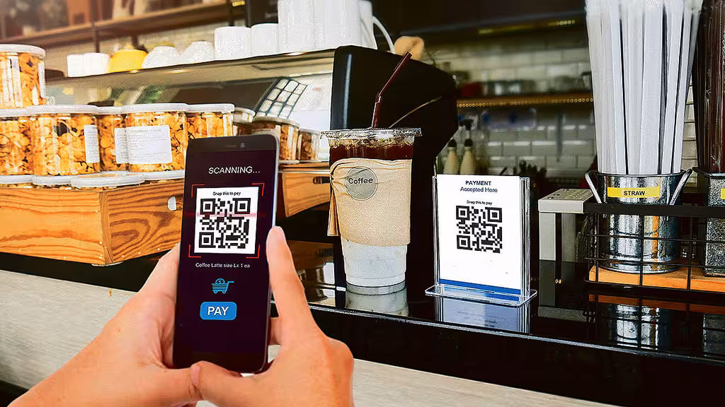 Customer scanning QR code for digital payment at a shop